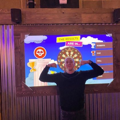 Owen Harris in front of AR Dart Board at Battle Bar Wandsworth 