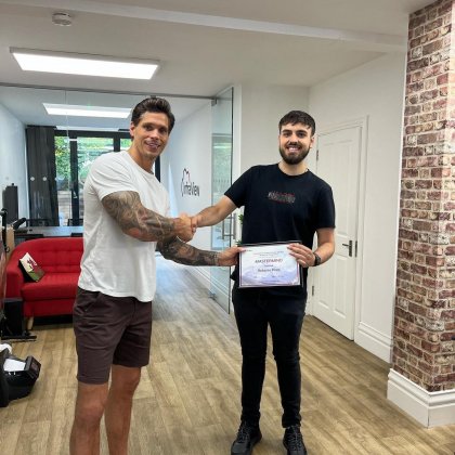 Tim Cazemage presenting Roberto with his certificate for passing the MasterMind Academy 